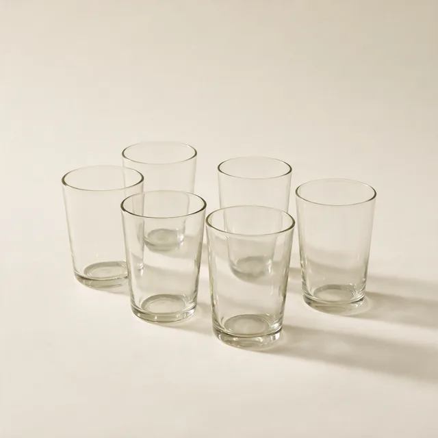 Six plain drinking glasses in a loose group