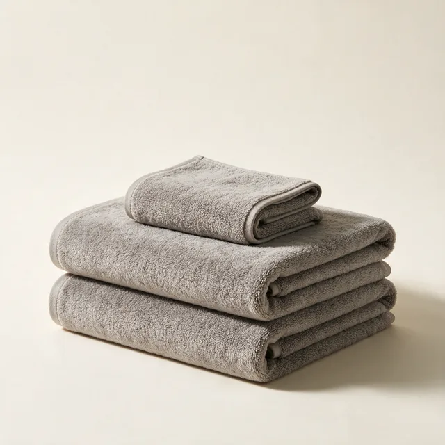 Two folded bath towels with a hand towel on top