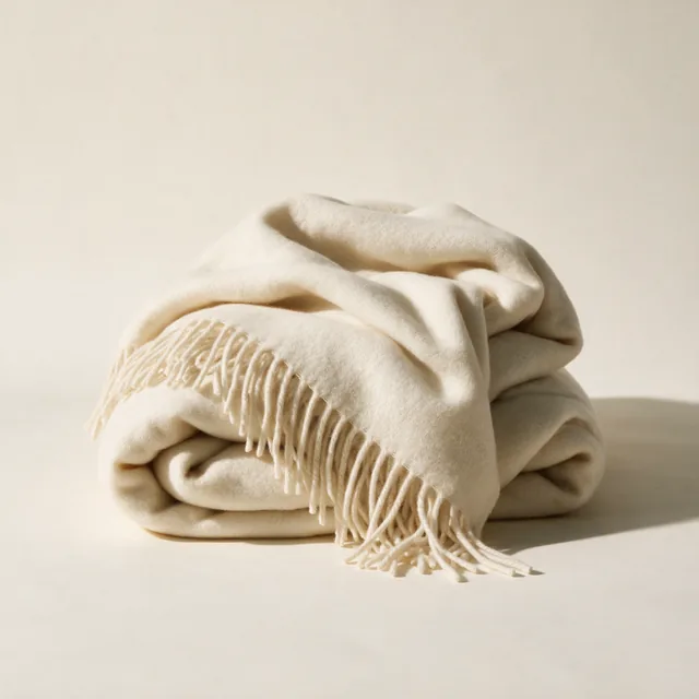A large wool throw folded in thick layers