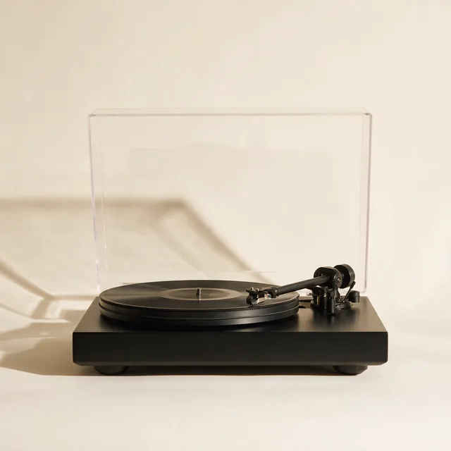 A belt drive turntable with a record on the platter