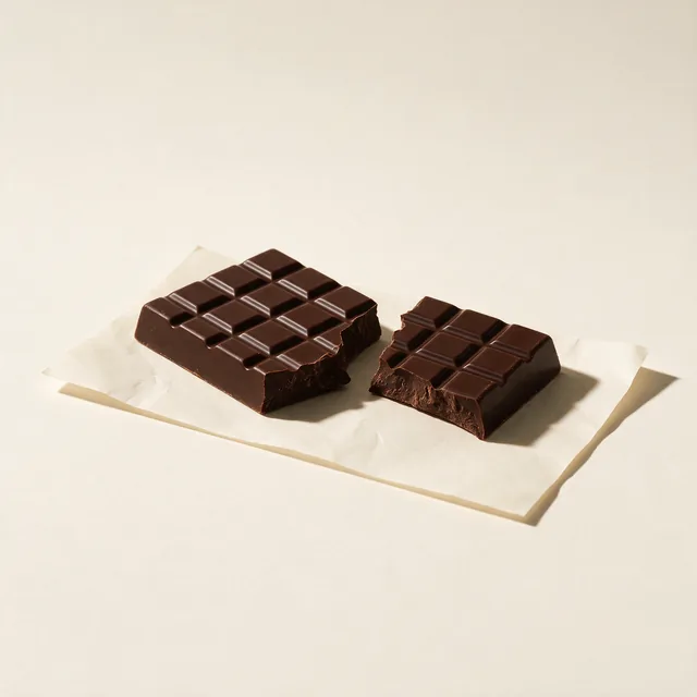 A bar of dark chocolate broken into two pieces