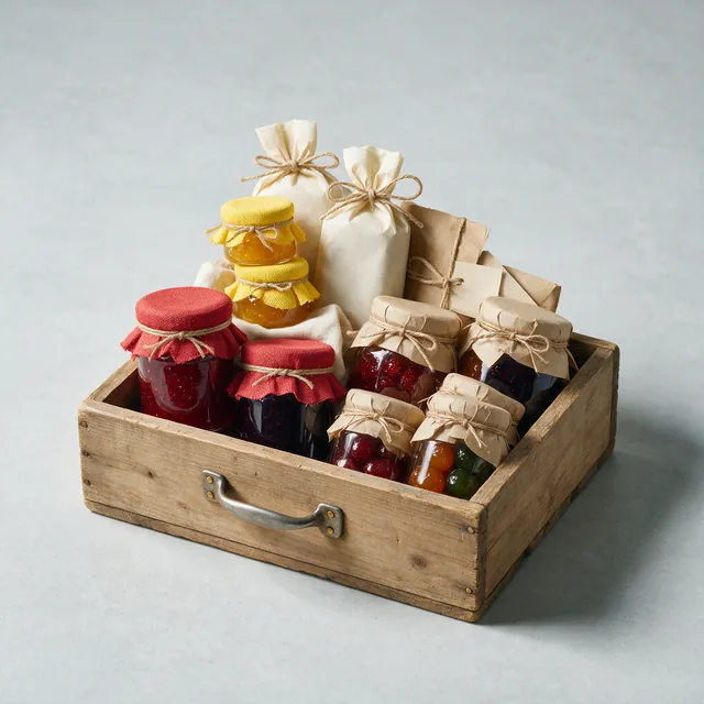 A wooden crate of assorted jars and packets