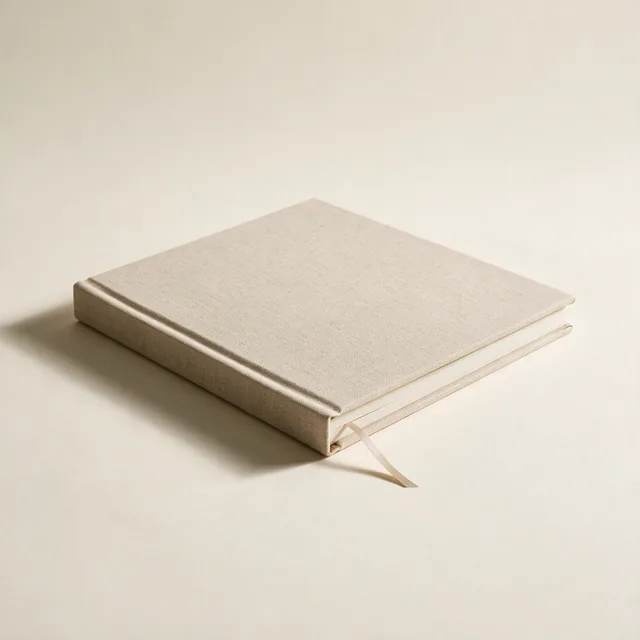 A closed linen-bound photo album with a ribbon marker