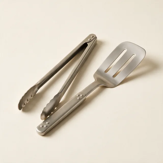 A stainless steel kitchen tongs