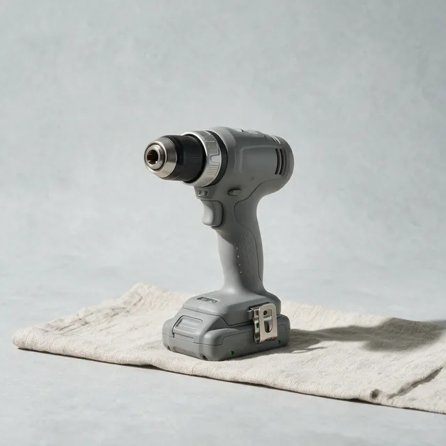 A cordless drill driver resting on its battery base