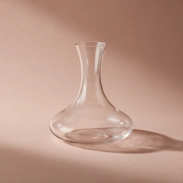A wide-bottomed glass wine decanter, empty