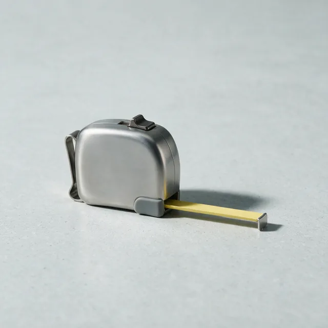 A wide retractable tape measure lying flat