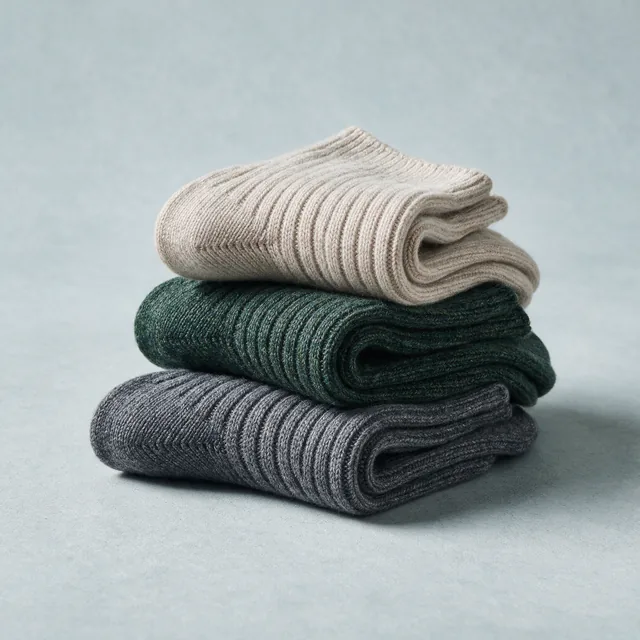 Three rolled pairs of ribbed wool socks